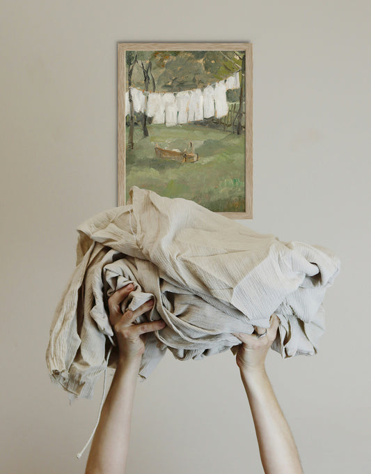 Framed vintage countryside wall art displayed in a bright farmhouse laundry room, creating a warm cottage-inspired space with timeless character.