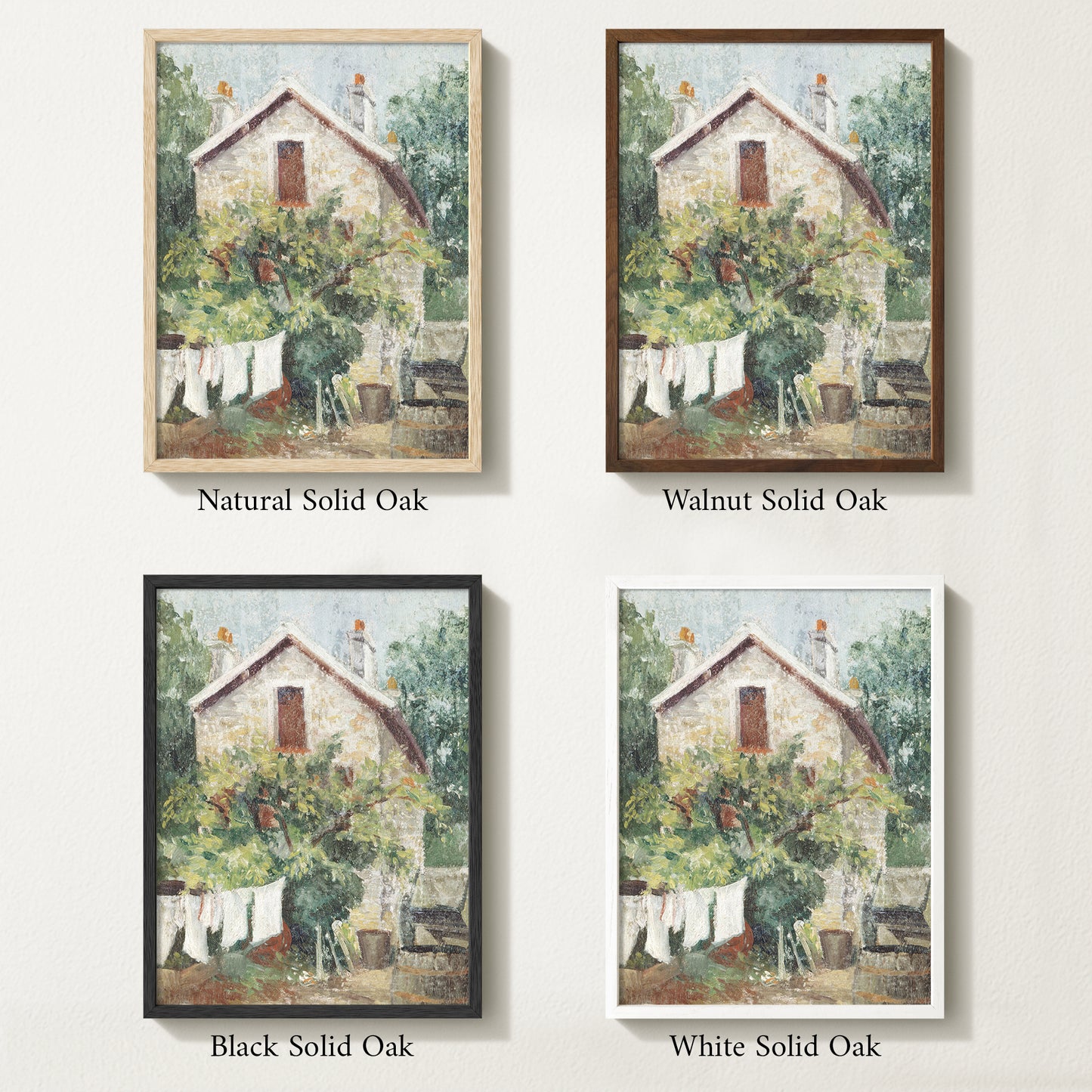 Framed vintage cottage art print featuring a stone house, lush greenery, and white laundry hanging on a clothesline in the garden.