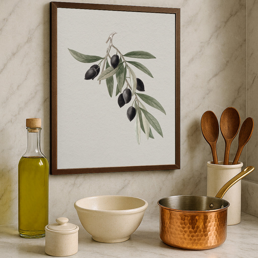 Framed artwork of an olive branch illustration on a kitchen counter with an olive oil bottle.