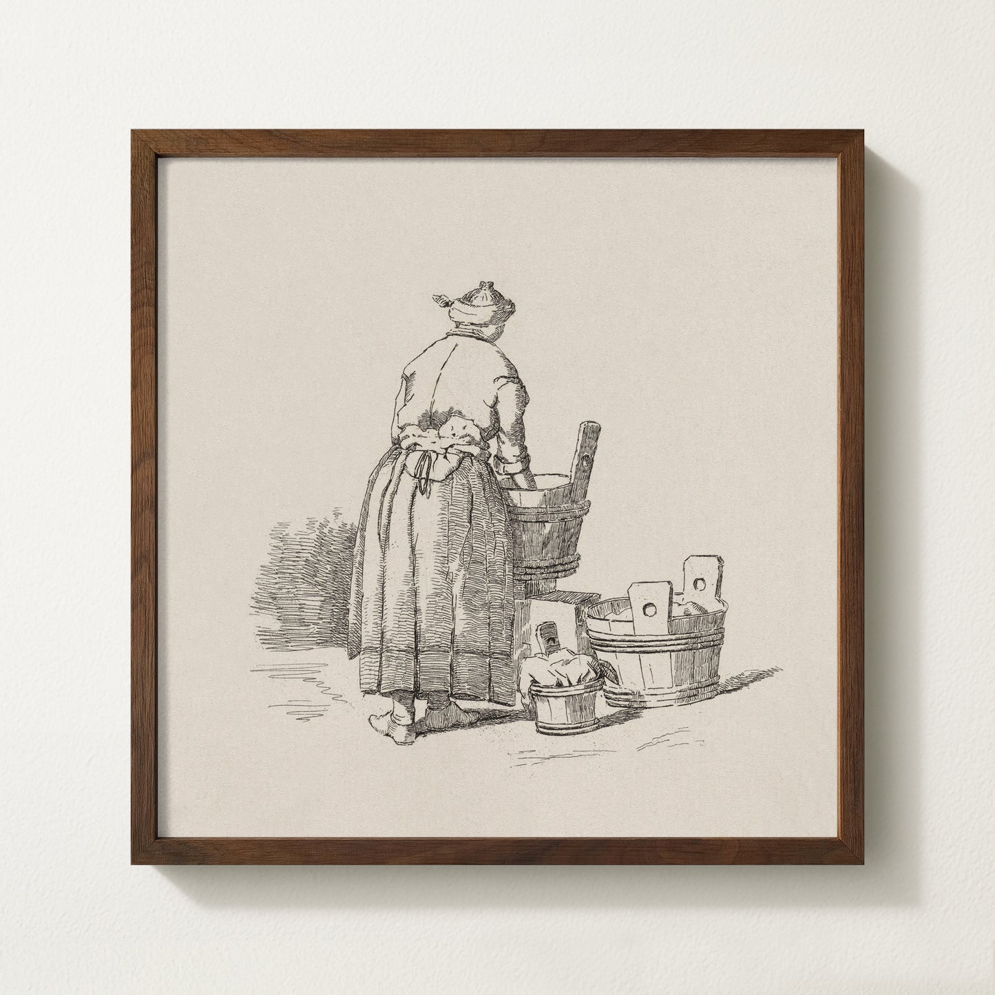 Framed vintage laundry sketch art print depicting a woman standing at wooden wash tubs in traditional attire.