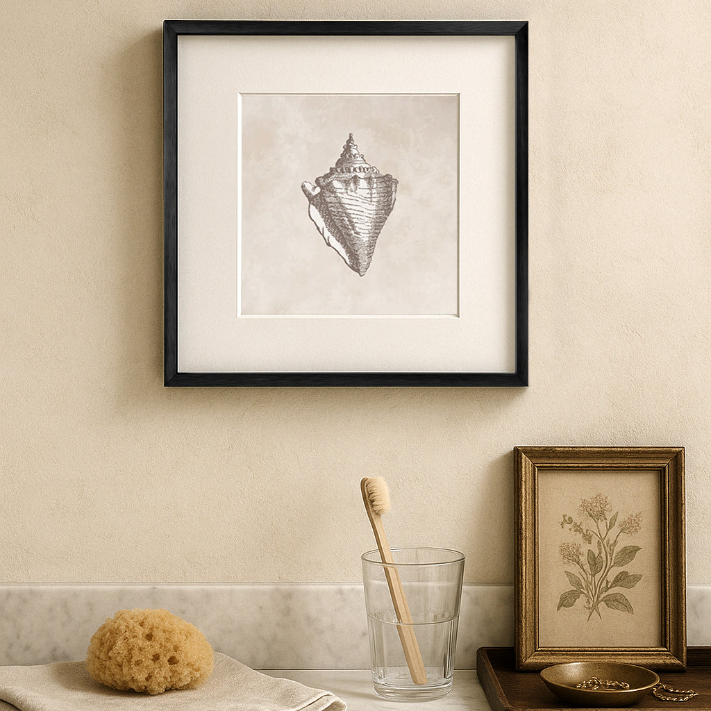 Framed vintage seashell art print in a black oak frame, styled in a bathroom.