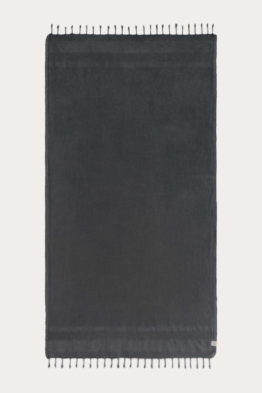 Avery Home black waffle weave peshtemal Turkish towel laid flat with hand-knotted tassel fringe – lightweight fast-drying luxurious spa towel