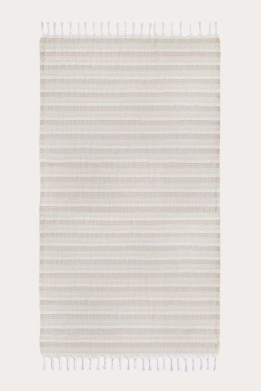 Avery Home Formentera beige and white herringbone peshtemal laid flat, full view of quick-dry Turkish cotton hammam towel with tassel fringe, for beach, spa, and bath