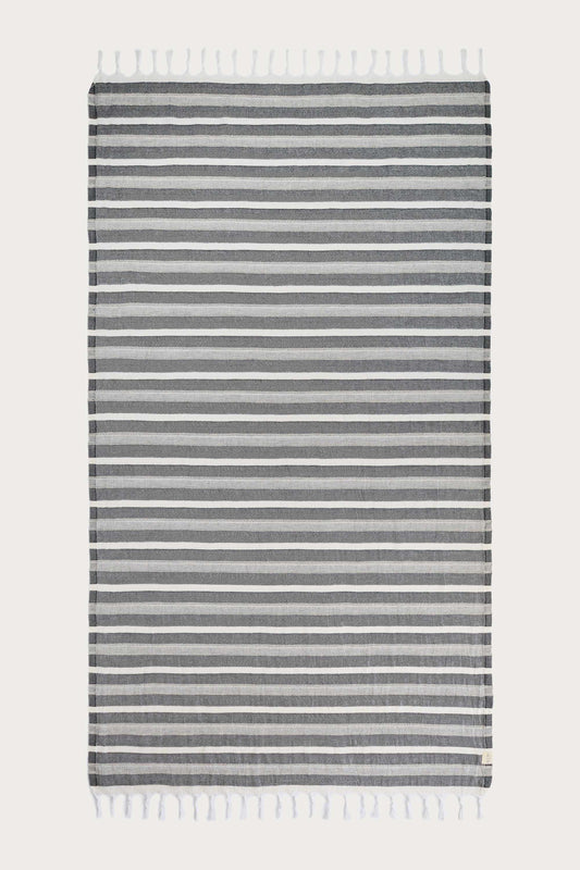Avery Home Formentera black and white herringbone peshtemal laid flat, full view of quick-dry Turkish cotton hammam towel with tassel fringe, for beach, spa, and bath