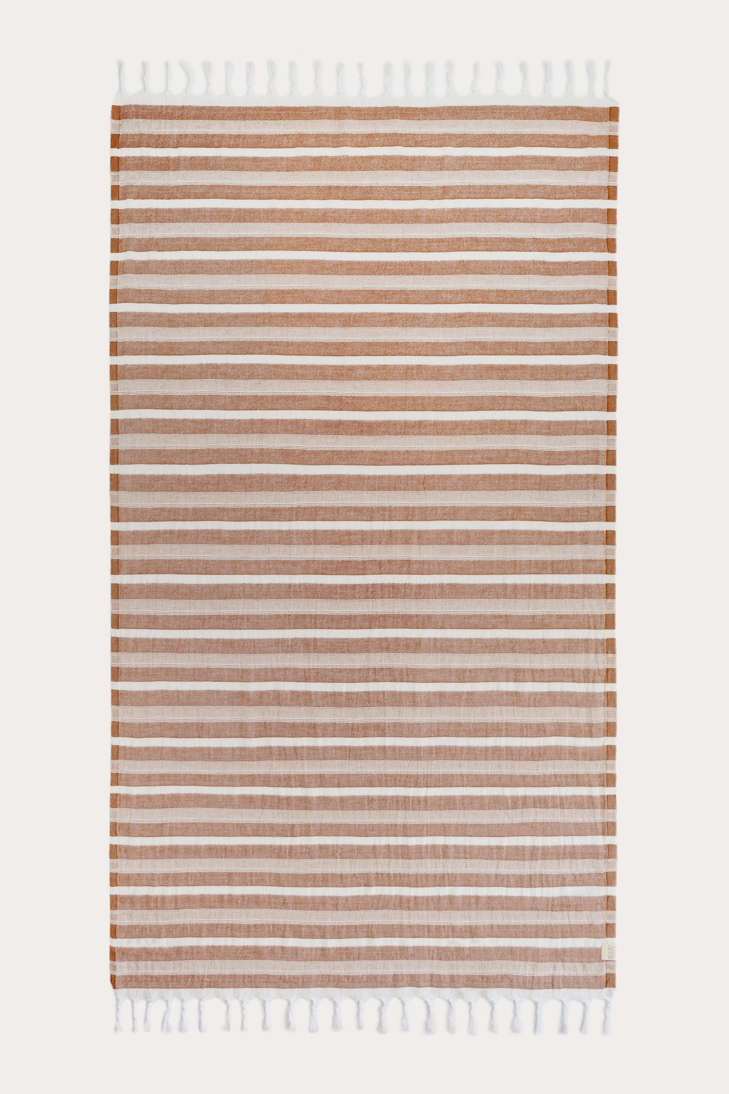Avery Home Formentera terracotta herringbone peshtemal laid flat, full view of quick-dry Turkish cotton hammam towel with tassel fringe, for beach, spa, and bath