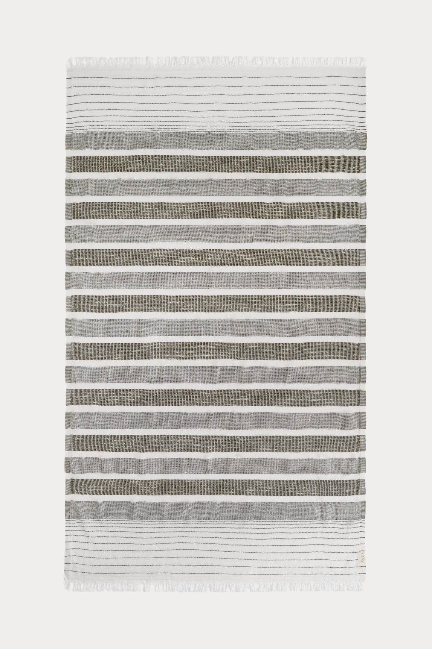 Avery Home green and white stripe peshtemal laid flat, full view of sustainable Turkish towel woven from recycled cotton and recycled polyester, with tassel fringe