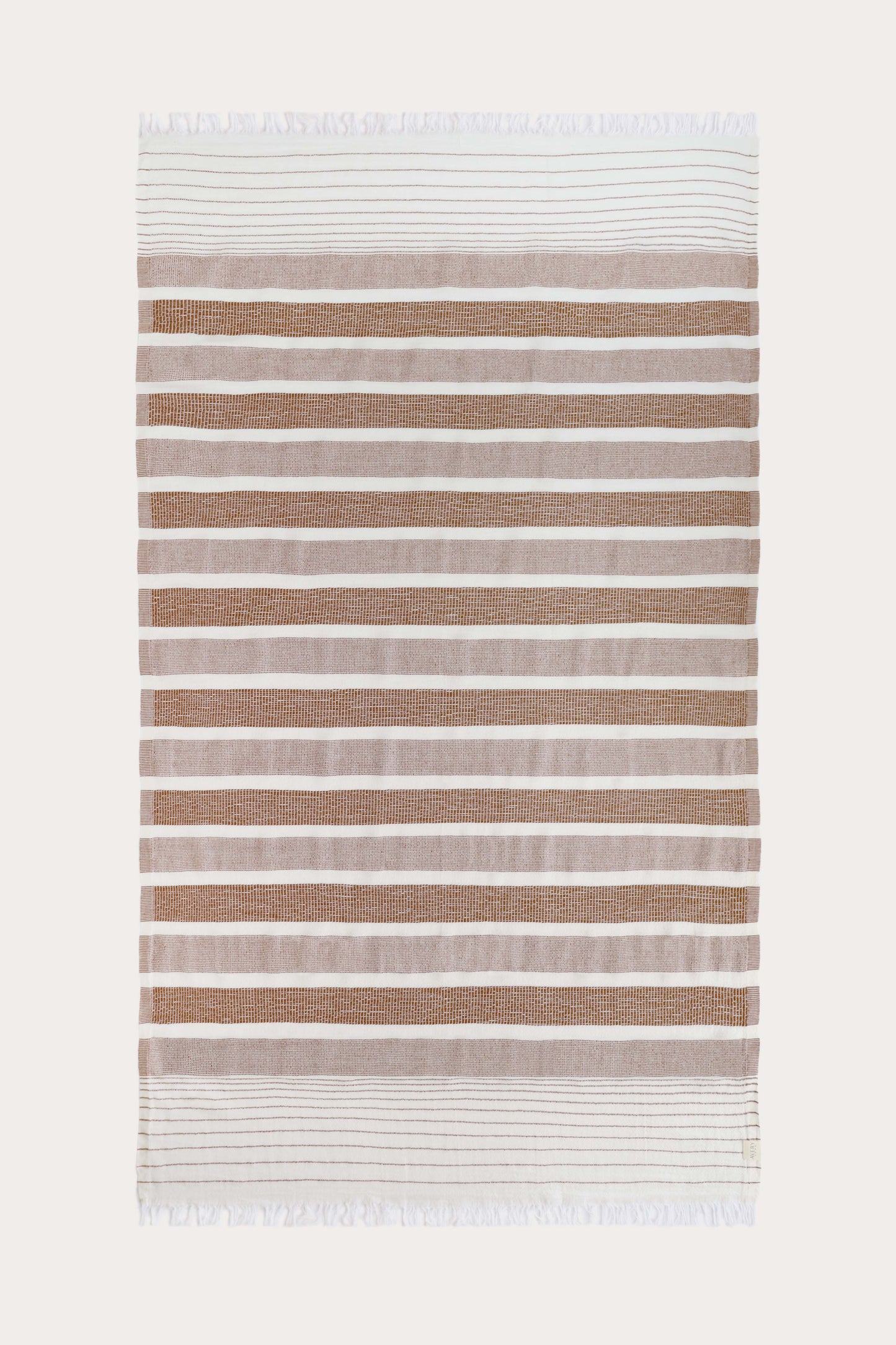 Avery Home terracotta and white stripe peshtemal laid flat, full view of sustainable Turkish towel woven from recycled cotton and recycled polyester, with tassel fringe