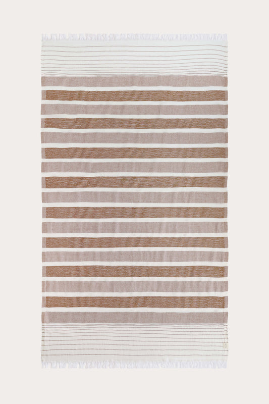 Avery Home terracotta and white stripe peshtemal laid flat, full view of sustainable Turkish towel woven from recycled cotton and recycled polyester, with tassel fringe