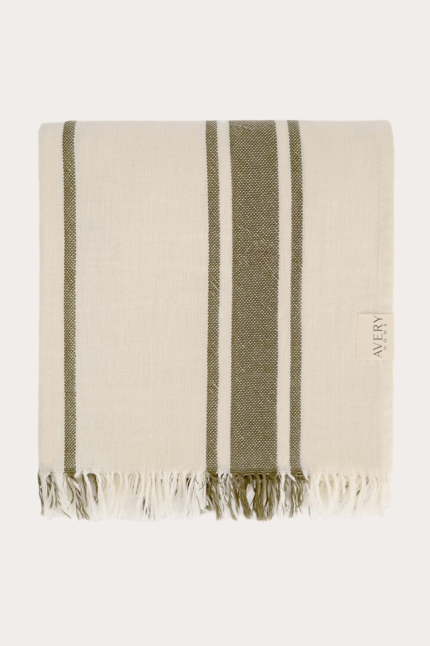 Folded green and beige Amalfi Turkish towel in 100% motton with cabana stripe pattern and fringe edges, midweight flat weave by Avery Home
