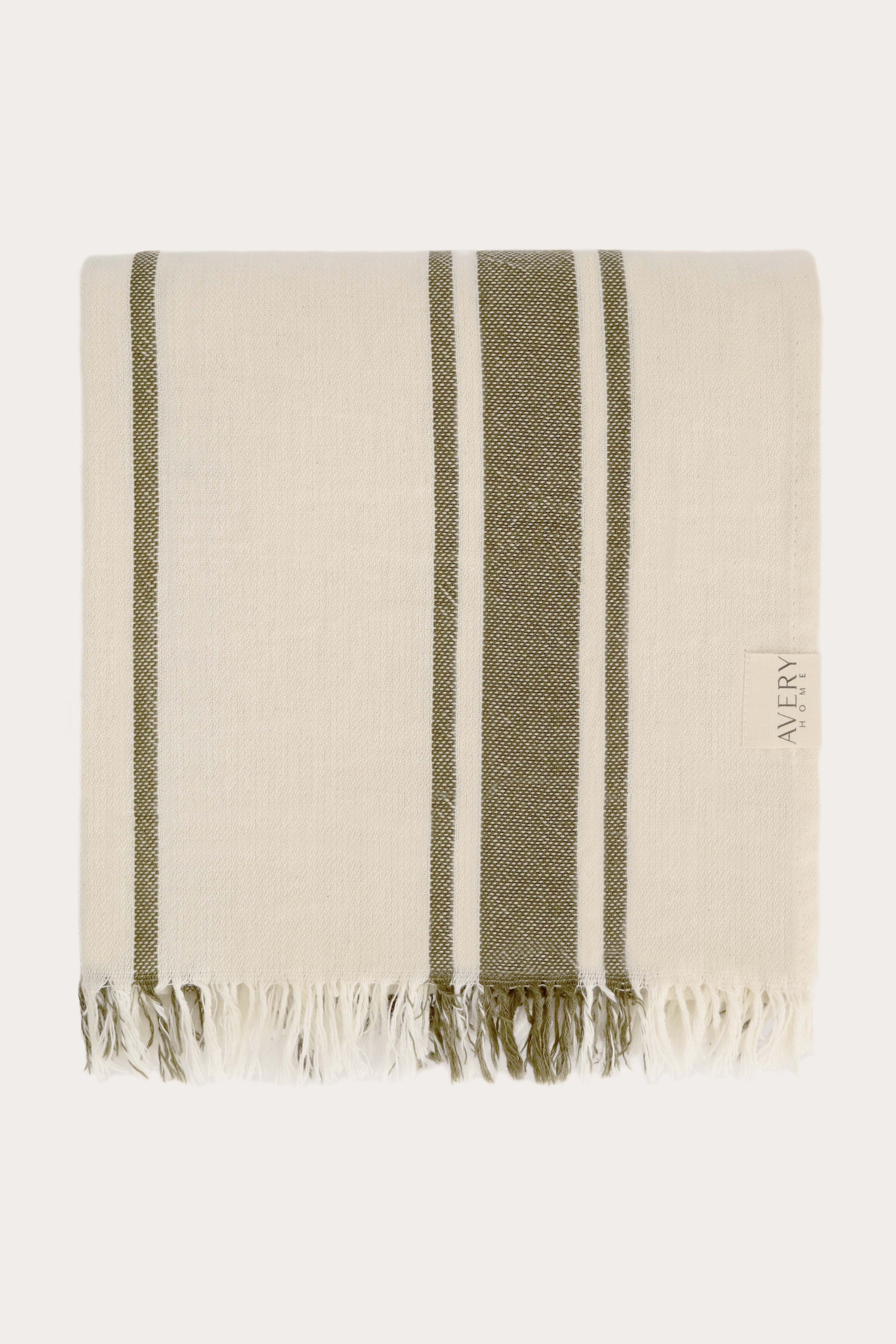 Folded green and beige Amalfi Turkish towel in 100% motton with cabana stripe pattern and fringe edges, midweight flat weave by Avery Home
