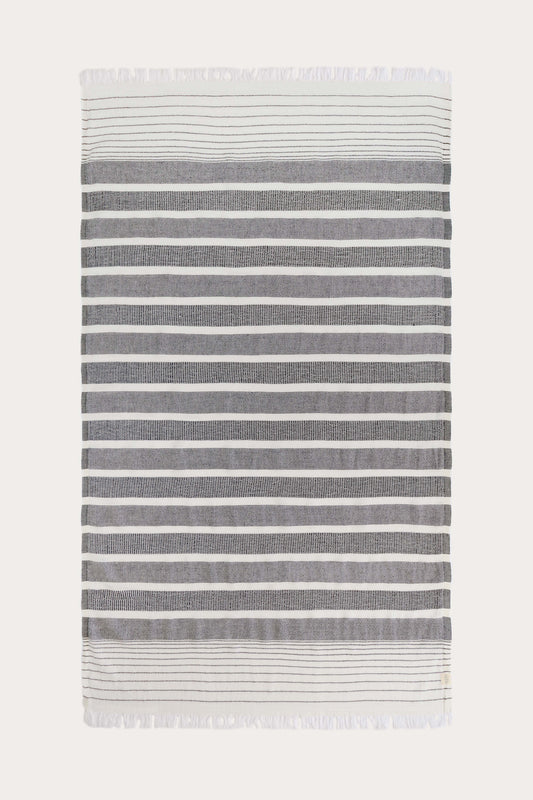 Full view of Milos black and white Turkish towel in recycled cotton blend with striped pattern, lightweight textured weave and fast-drying design by Avery Home