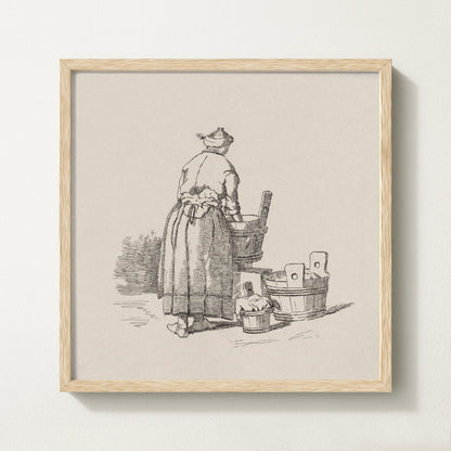 Framed vintage laundry sketch art print depicting a woman standing at wooden wash tubs in traditional attire.
