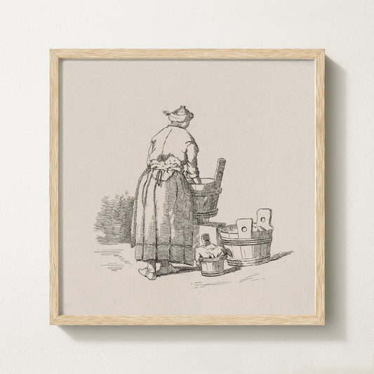 Framed vintage laundry sketch art print depicting a woman standing at wooden wash tubs in traditional attire.