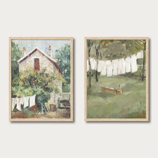 Set of two vintage laundry scene art prints featuring outdoor clotheslines and cottages, available unframed or with oak frames — Avery Home.