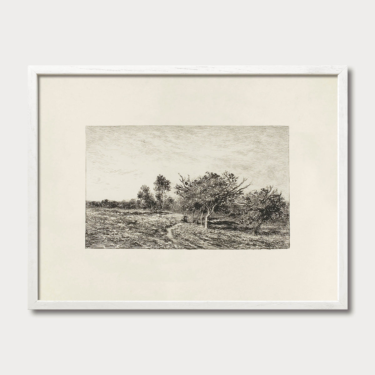 Black-and-white countryside landscape print in a white oak frame, a neutral artwork for cottage-inspired interiors.